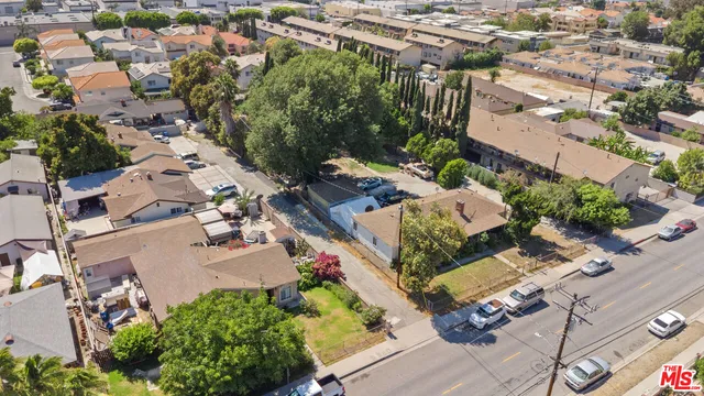 an aerial view of multiple houses with yard