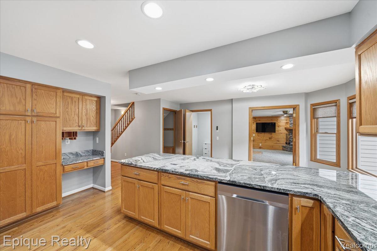 1221 Rhodes Road Lake Orion, MI 48360 - Photo 14 of 72 Kitchen featuring wood-finish cabinetry, a large center island with a stone countertop, and recessed lighting