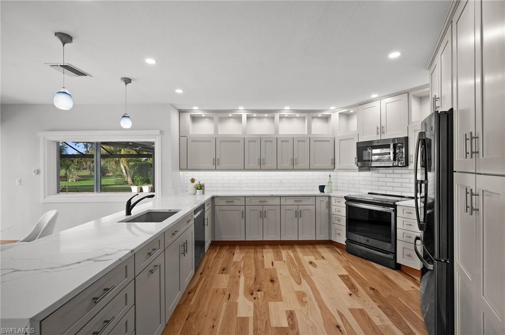 2012 Prince Drive Naples, FL 34110 - Photo 12 of 41 a large kitchen with a sink and stainless steel appliances