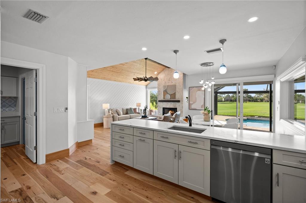 2012 Prince Drive Naples, FL 34110 - Photo 13 of 41 a kitchen with sink cabinets and wooden floor