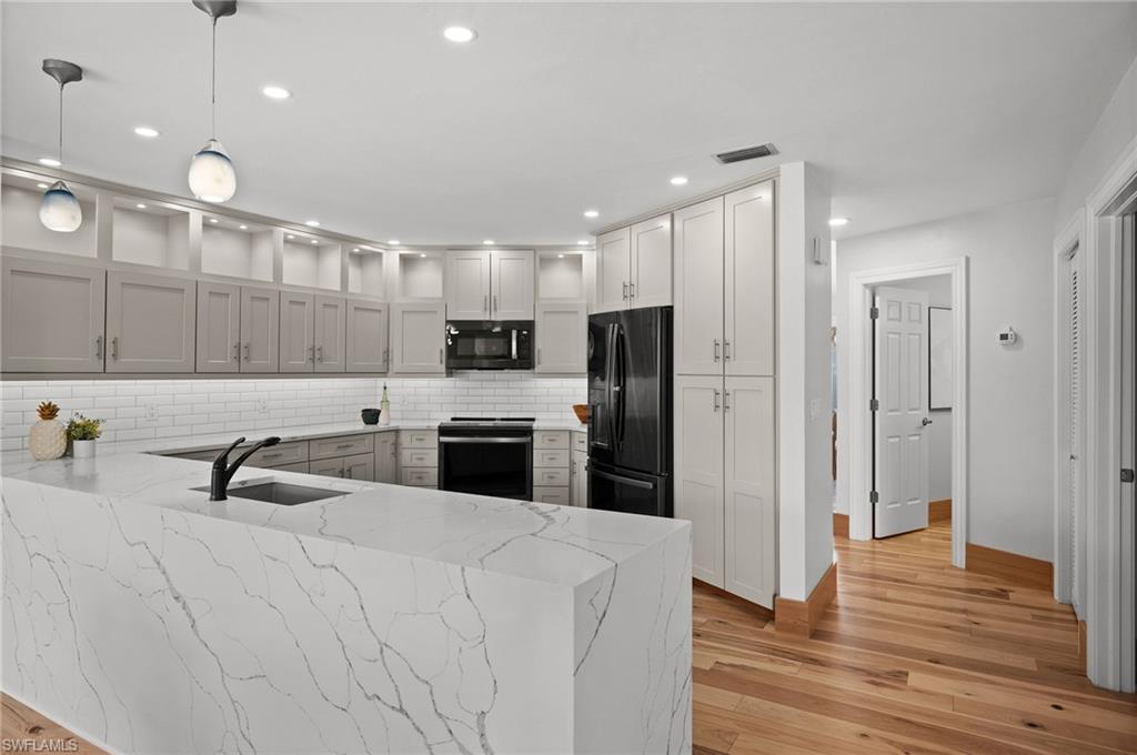 2012 Prince Drive Naples, FL 34110 - Photo 15 of 41 a large white kitchen with a refrigerator a sink and a stove