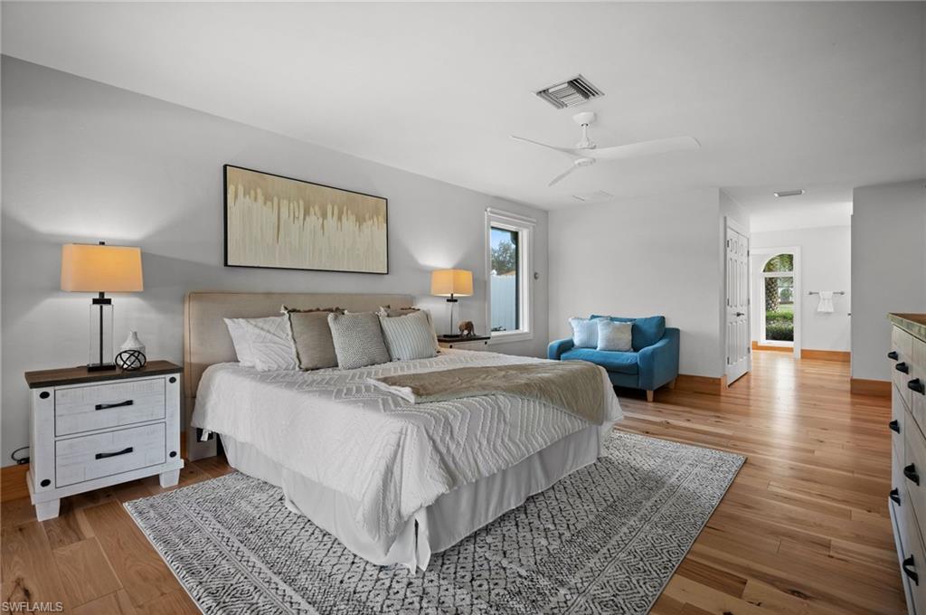 2012 Prince Drive Naples, FL 34110 - Photo 25 of 41 a spacious bedroom with a bed and wooden floor