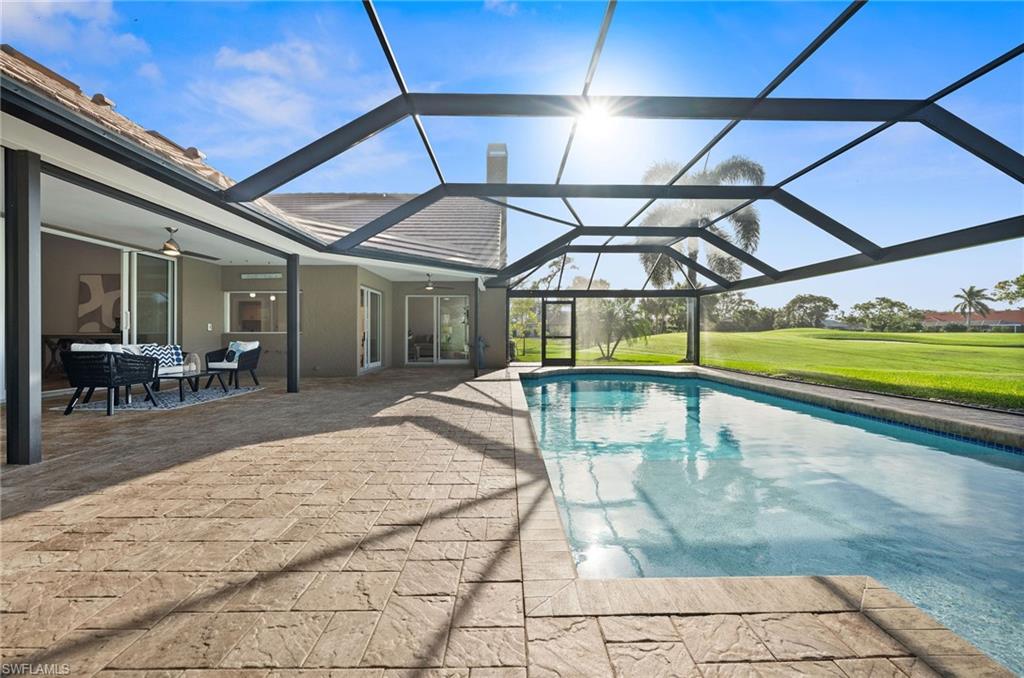 2012 Prince Drive Naples, FL 34110 - Photo 37 of 41 a view of a swimming pool with a patio