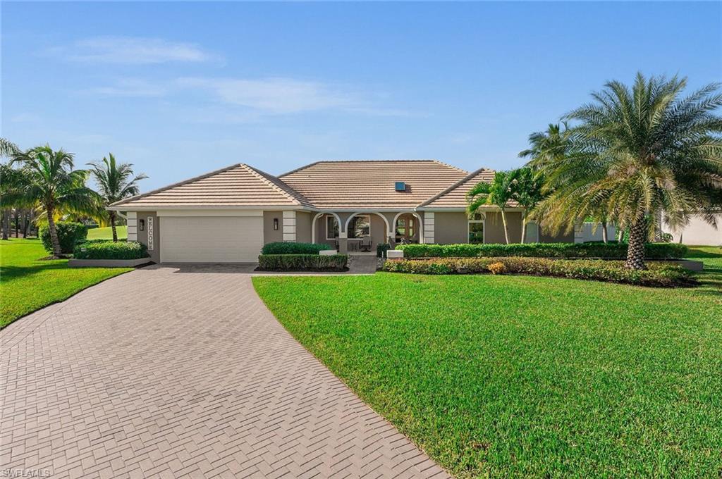 2012 Prince Drive Naples, FL 34110 - Photo 41 of 41 a front view of a house with a yard and garage