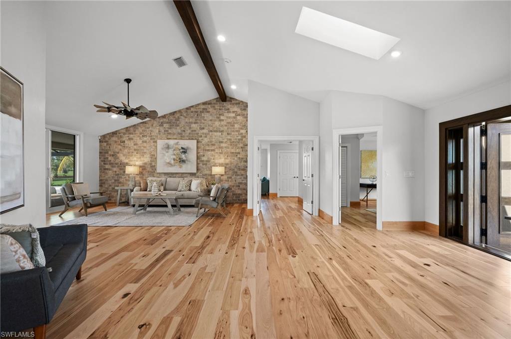 2012 Prince Drive Naples, FL 34110 - Photo 8 of 41 a spacious bedroom with a bed and wooden floor