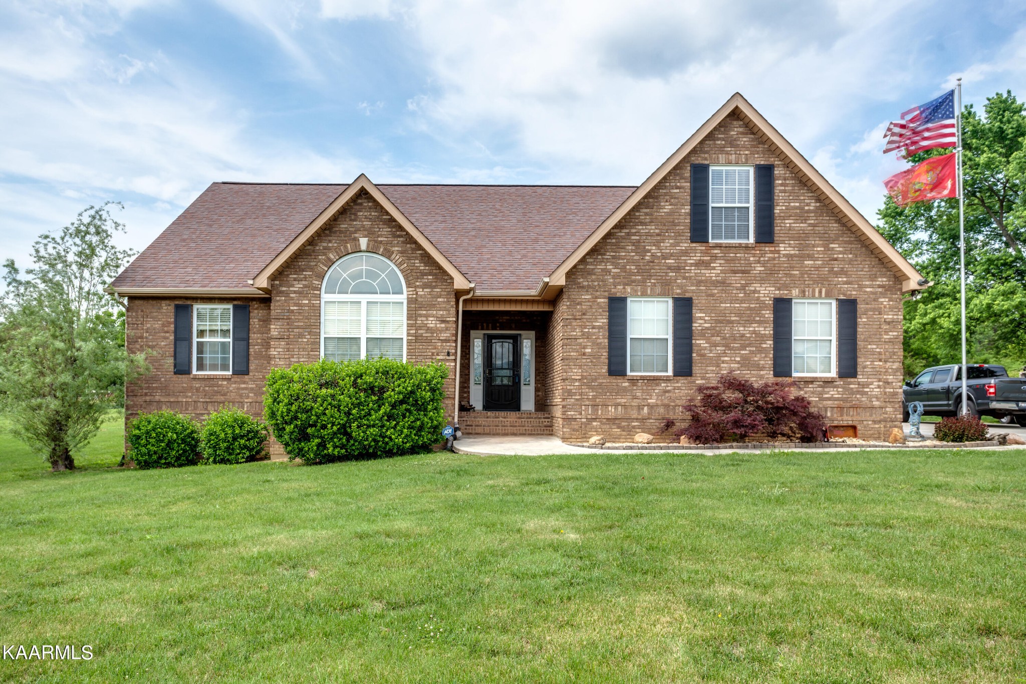 a front view of a house with a yard and garage