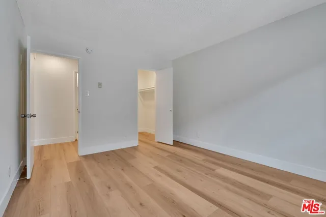 a view of an empty room and wooden floor