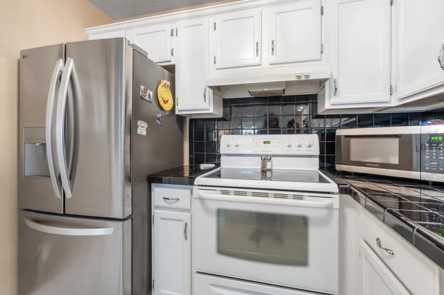 a kitchen with a sink cabinets and appliances