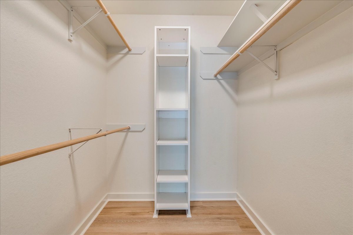 2811 Hardeman Street, Unit B Austin, TX 78704 - Photo 17 of 34 Custom shelving and hanging rods maximize storage space above wood floors.