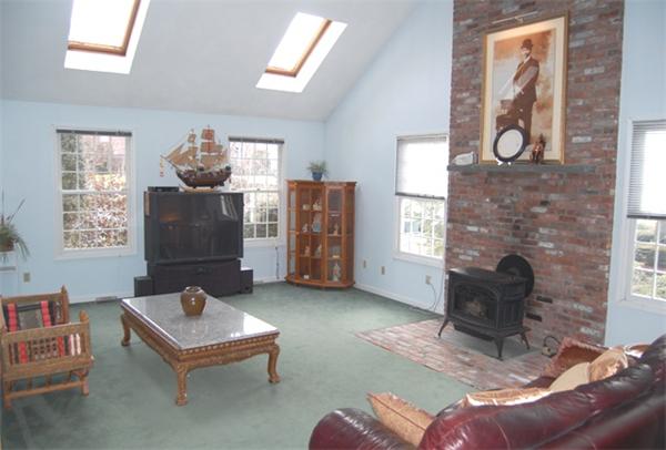 155 East Emerson Road Lexington, MA 02420 - Photo 4 of 18 a living room with furniture and a fireplace