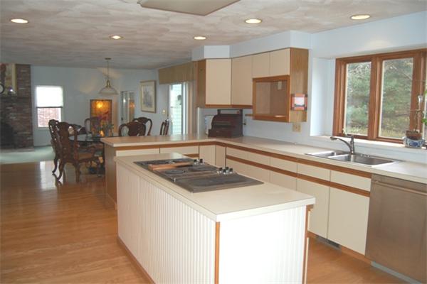 155 East Emerson Road Lexington, MA 02420 - Photo 8 of 18 a kitchen with stainless steel appliances granite countertop a sink a stove and a refrigerator