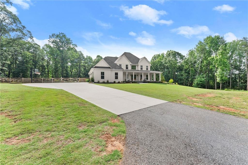 6998 Britt Gailey Road Clermont, GA 30527 - Photo 92 of 92 a view of a town with large trees and a big yard