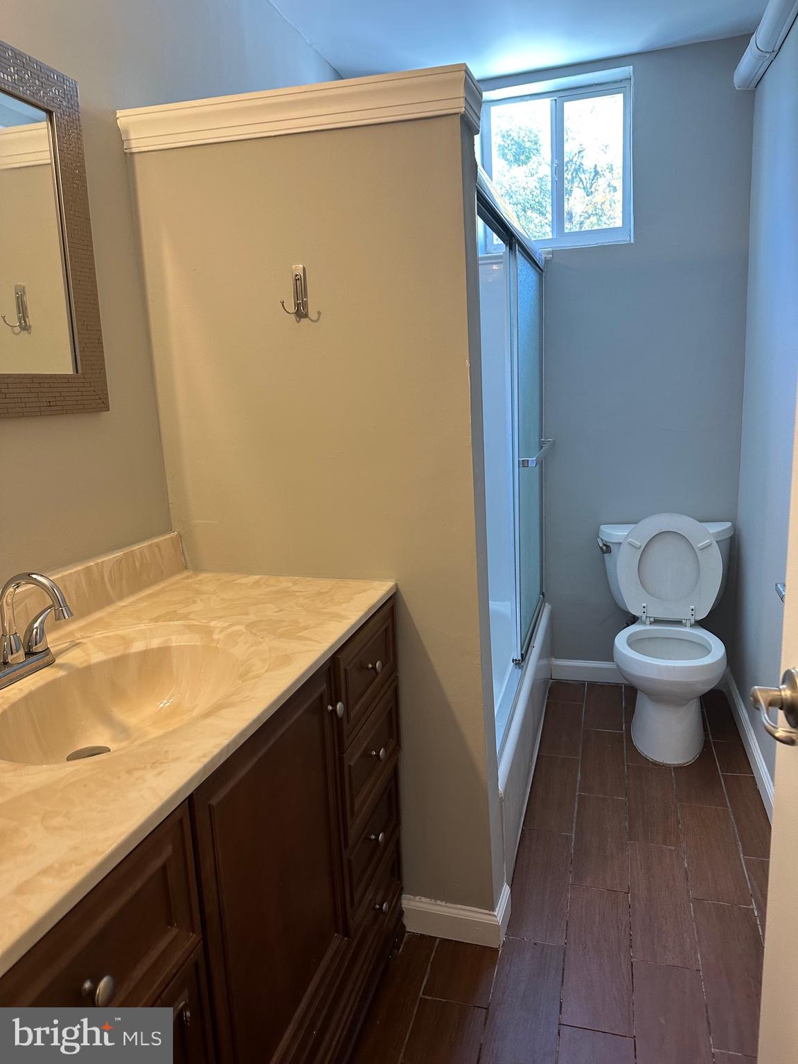 1200 South 22nd Street Philadelphia, PA 19146 - Photo 7 of 20 a bathroom with a granite countertop sink toilet and a mirror