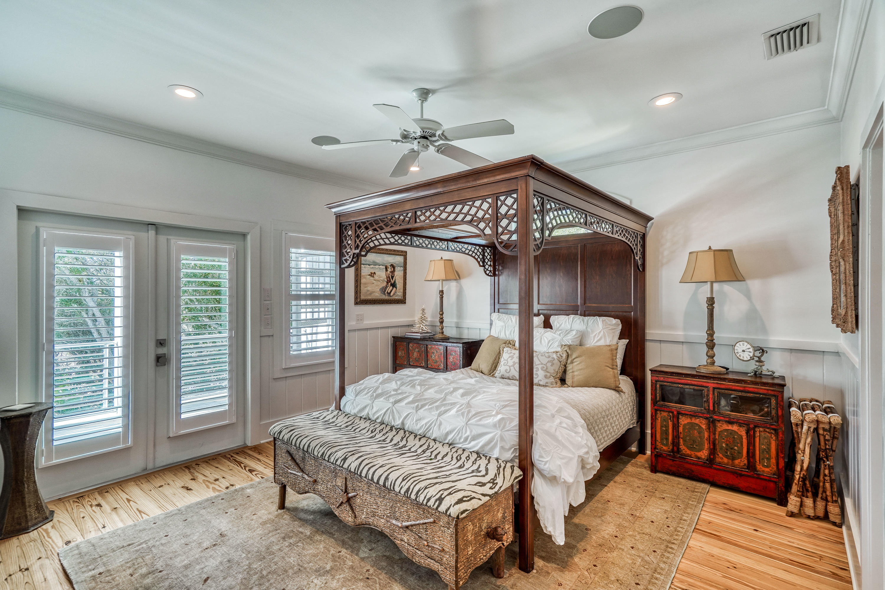 406 Defuniak Street Santa Rosa Beach, FL 32459 - Photo 37 of 87 a bedroom with a large bed a chandelier and dresser