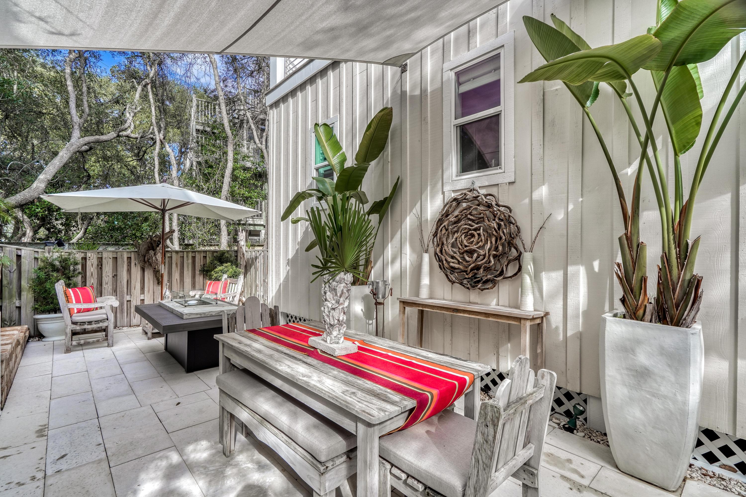 406 Defuniak Street Santa Rosa Beach, FL 32459 - Photo 52 of 87 a backyard of a house with barbeque oven table and chairs