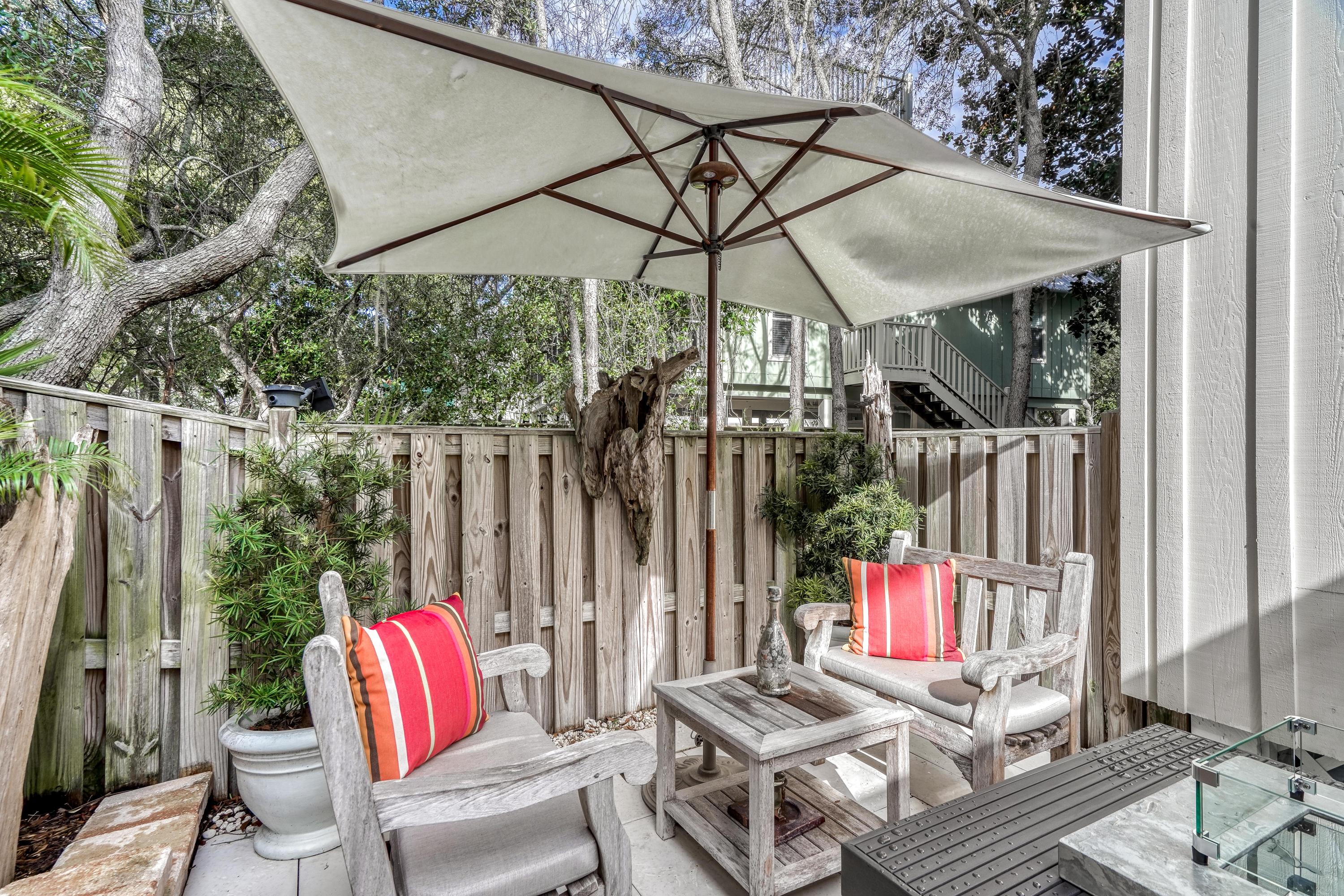406 Defuniak Street Santa Rosa Beach, FL 32459 - Photo 57 of 87 a view of patio with a table and chairs under an umbrella