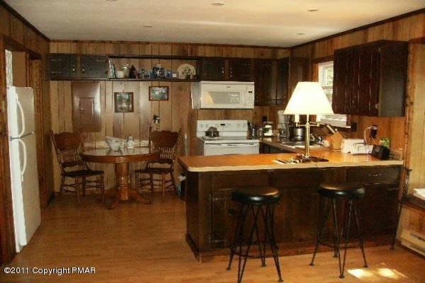 745 Hampstead Road Bushkill, PA 18324 - Photo 5 of 10 a kitchen with a sink refrigerator and cabinets