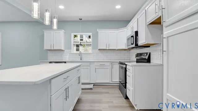 a kitchen with stainless steel appliances granite countertop a sink and a stove