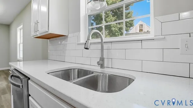 a bedroom with a bed a rug and a window