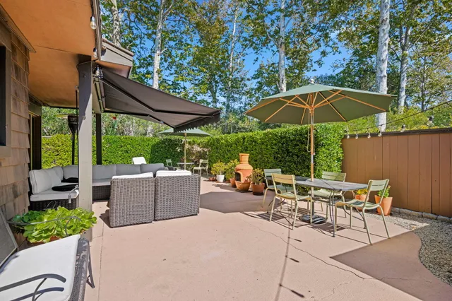 a view of a backyard with a patio and a garden