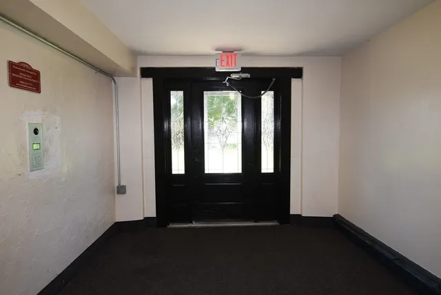 a view of a swimming pool with potted plants
