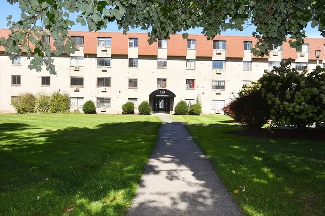 a aerial view of building with yard