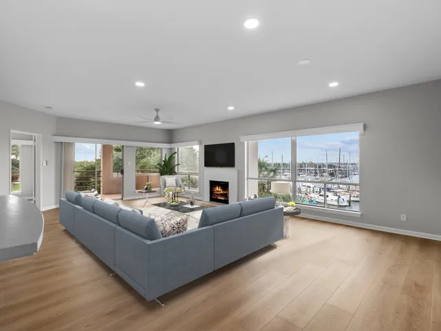 a living room with fireplace furniture and a large window