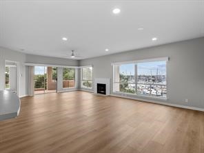 1302 Marina Bay Drive, Unit 201A Kemah, TX 77565 - Photo 14 of 43 a view of an empty room with wooden floor and a fireplace