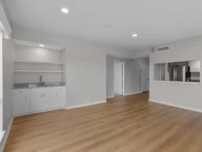 a view of an empty room with a kitchen