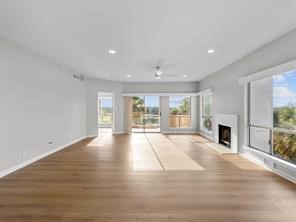 1302 Marina Bay Drive, Unit 201A Kemah, TX 77565 - Photo 19 of 43 a view of an empty room with fireplace and wooden floor