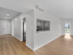 1302 Marina Bay Drive, Unit 201A Kemah, TX 77565 - Photo 20 of 43 a view of an empty room with wooden floor and a window