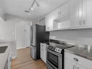 a kitchen with a stove microwave and refrigerator