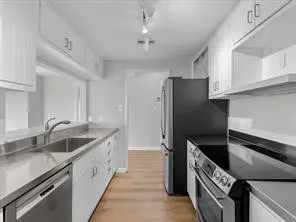 a kitchen with a refrigerator and a sink