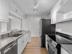 1302 Marina Bay Drive, Unit 201A Kemah, TX 77565 - Photo 24 of 43 a kitchen with a refrigerator and a sink