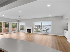 1302 Marina Bay Drive, Unit 201A Kemah, TX 77565 - Photo 26 of 43 a view of an empty room with wooden floor and a fireplace
