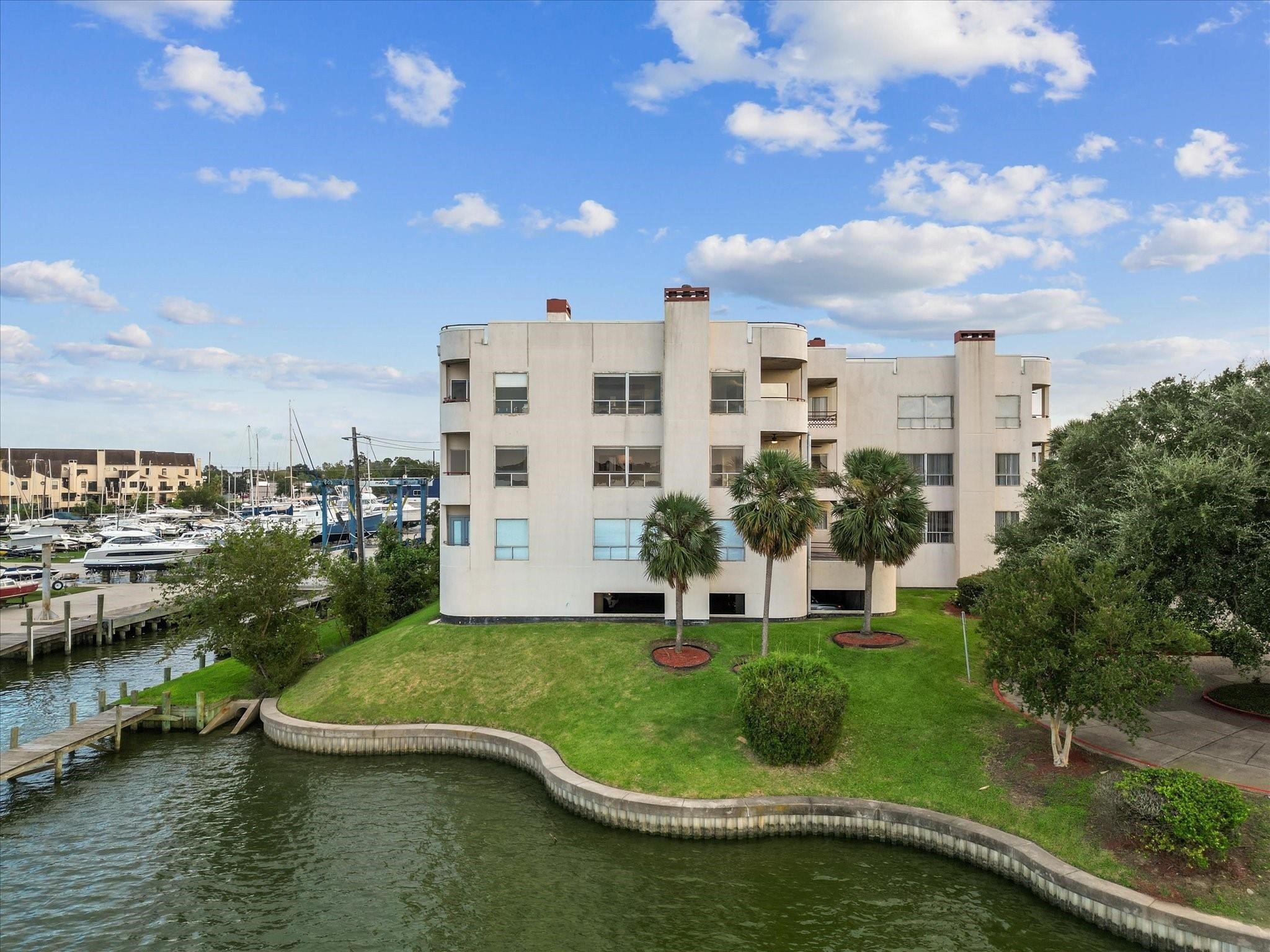 1302 Marina Bay Drive, Unit 201A Kemah, TX 77565 - Photo 3 of 43 a view of a lake with a building in the background