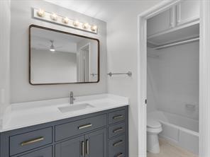 1302 Marina Bay Drive, Unit 201A Kemah, TX 77565 - Photo 32 of 43 a bathroom with a toilet sink and mirror