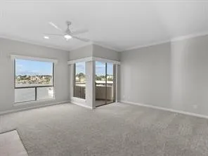 a view of an empty room with window and cabinet