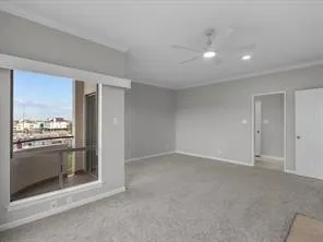 an empty room with a kitchen and a fireplace