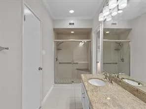 a bathroom with a granite countertop sink mirror and shower