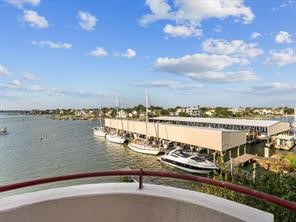 1302 Marina Bay Drive, Unit 201A Kemah, TX 77565 - Photo 42 of 43 a view of a lake next to a building