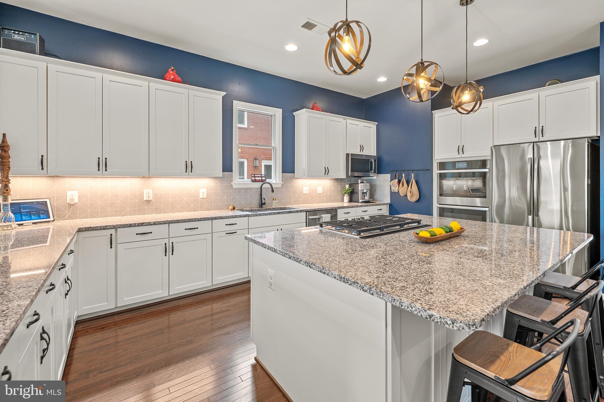 8459 Reformatory Way Lorton, VA 22079 - Photo 12 of 78 a kitchen with a sink a center island a stove cabinets and living room view