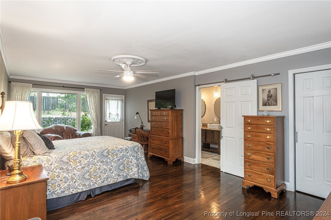 2539 Huntington Road Fayetteville, NC 28303 - Photo 20 of 39 a bedroom with a bed and wooden floor