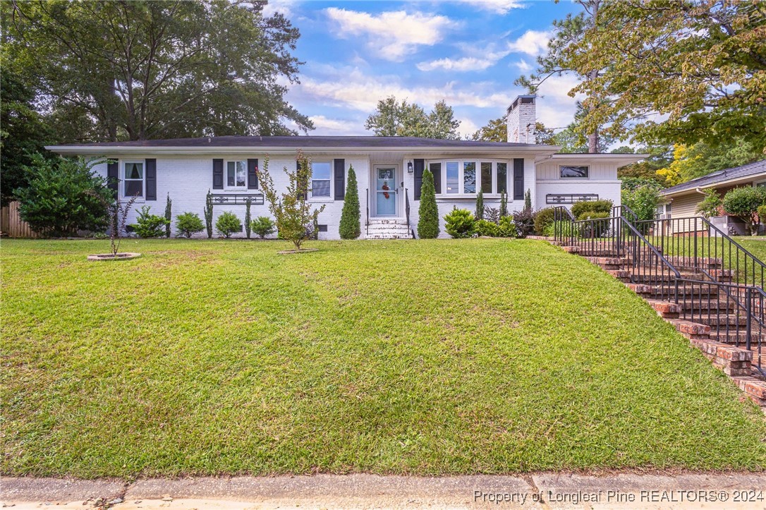 2539 Huntington Road Fayetteville, NC 28303 - Photo 2 of 39 a view of a big house with a big yard and large trees
