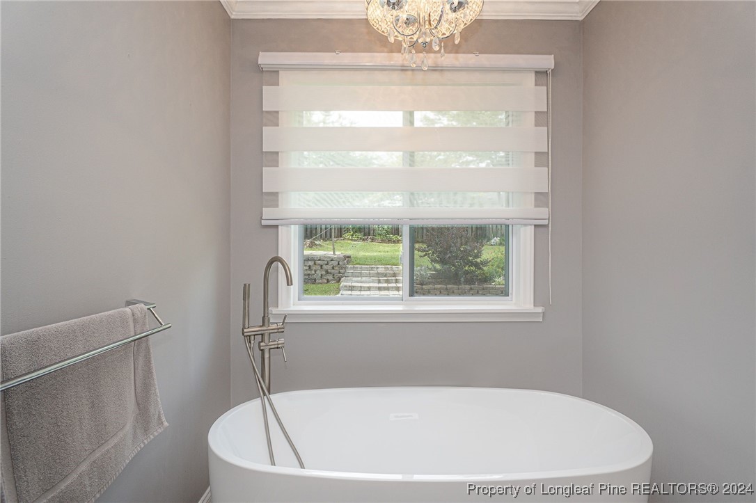 2539 Huntington Road Fayetteville, NC 28303 - Photo 24 of 39 a white bath tub sitting in a bathroom next to a window