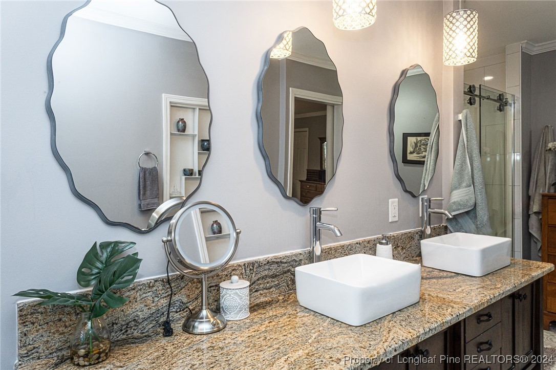 2539 Huntington Road Fayetteville, NC 28303 - Photo 25 of 39 a bathroom with sinks granite vanity and a mirror