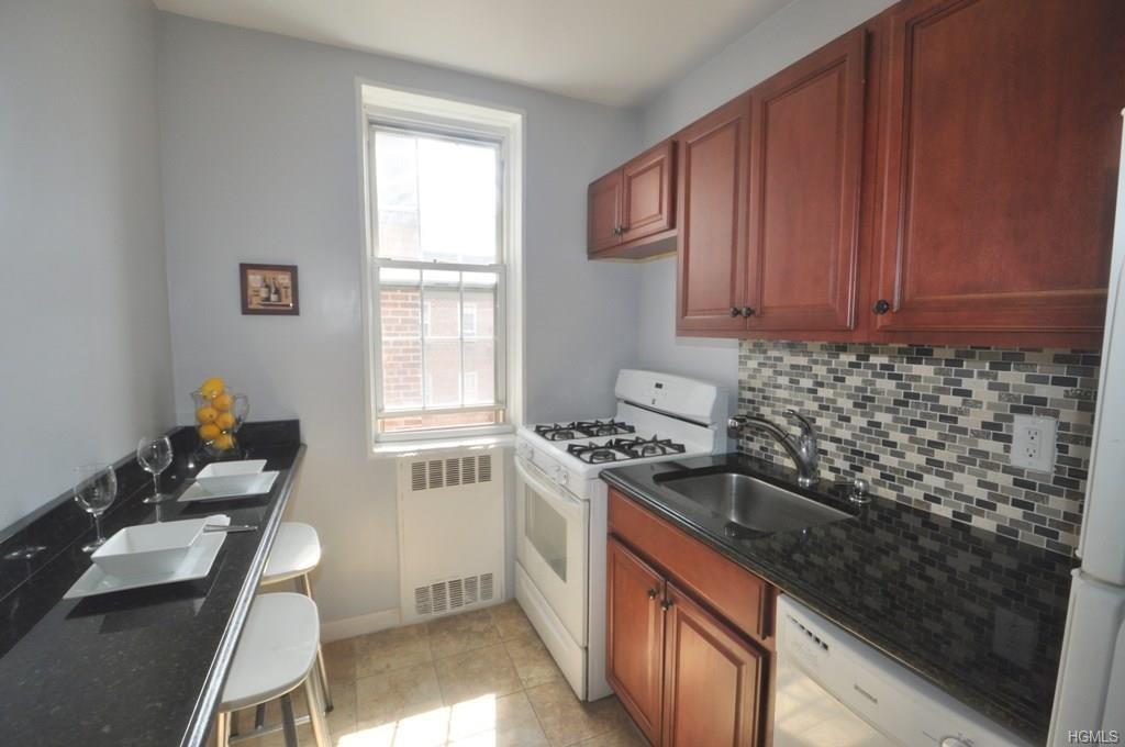a kitchen with a sink stove top oven and cabinets