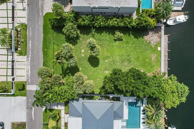 an aerial view of a house with garden space and lake view