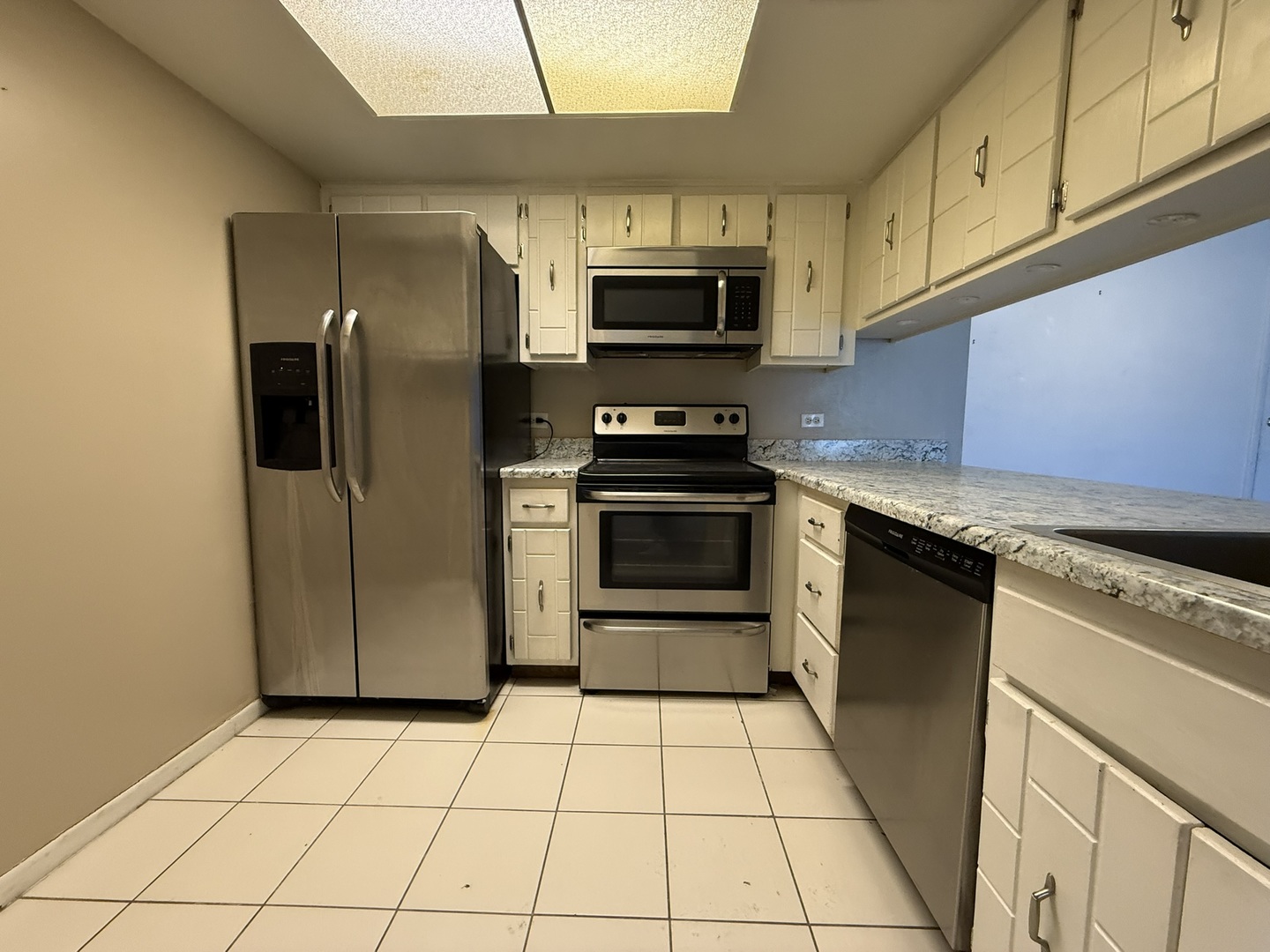 830 Elder Road, Unit 111 Homewood, IL 60430 - Photo 7 of 15 a kitchen with stainless steel appliances granite countertop a refrigerator and a stove top oven