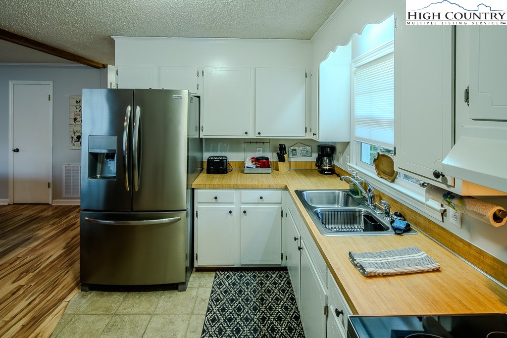 198 Black Pine Road Newland, NC 28657 - Photo 12 of 34 a kitchen with a refrigerator a sink and a stove